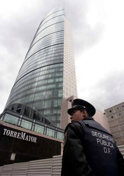 A Mexico City police officer stands guard outside Latin America's tallest building, Torre Mayor [REUTERS/Henry Romero (MEXICO)]